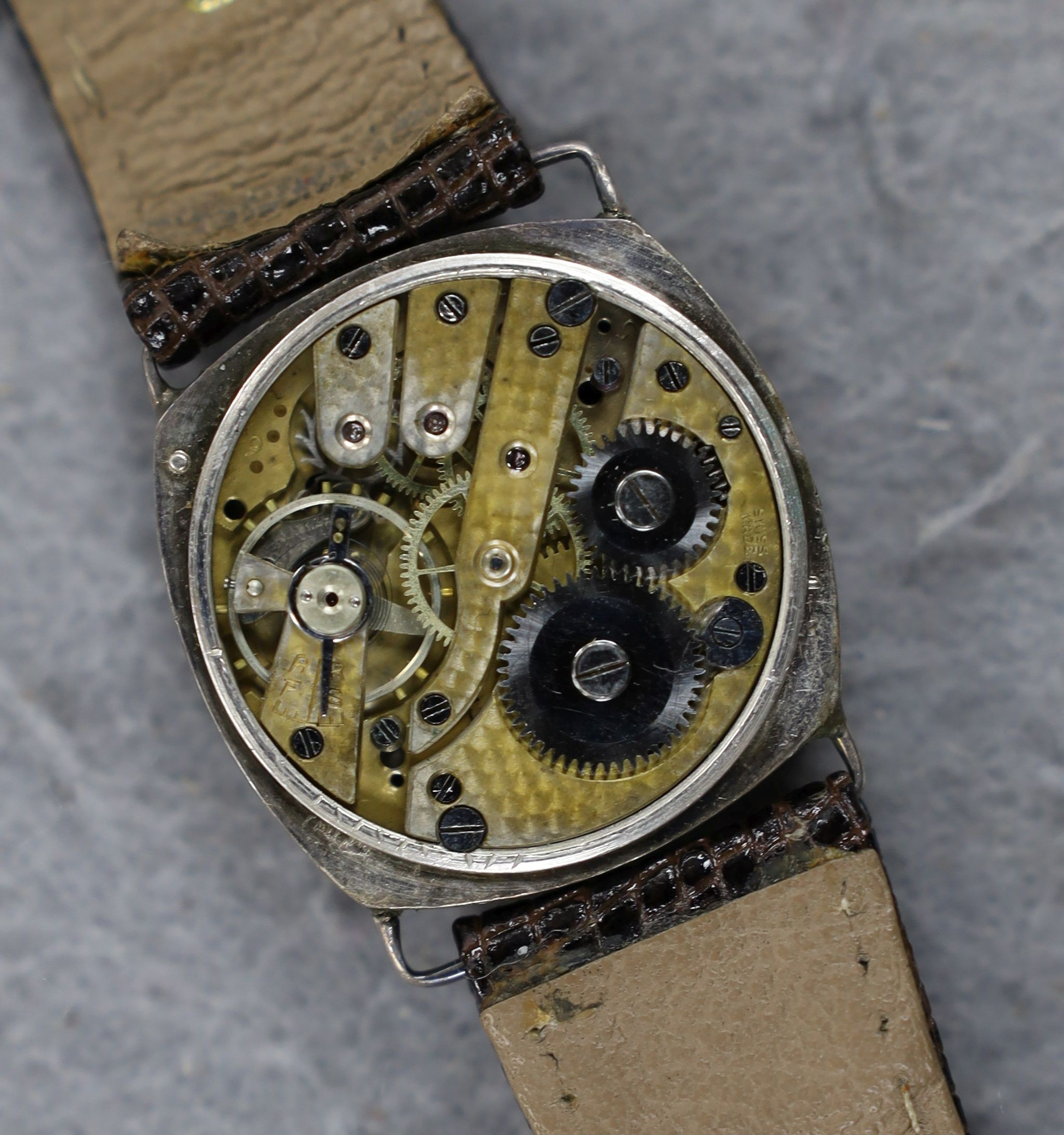A gentleman's 1920's silver wrist watch, with Arabic dial and subsidiary seconds, the dial signed Rolex, movement unsigned, lacking winding crown.
